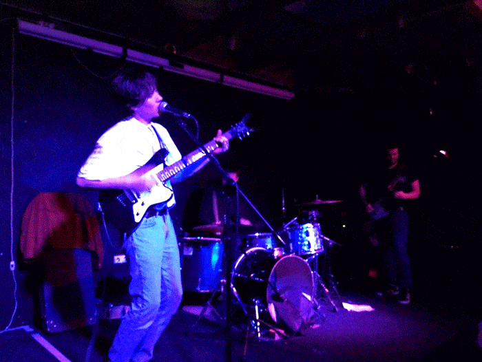 Man playing guitar with a band